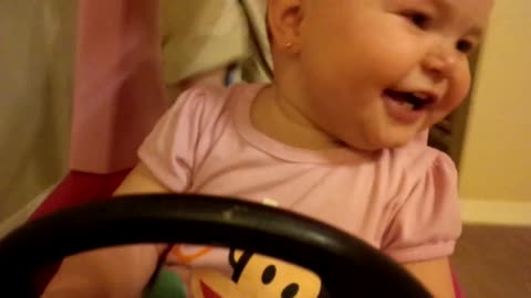 Baby takes toy car for a joy ride