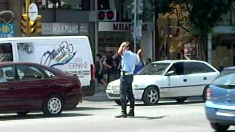 Police officer chats on phone while conducting traffic