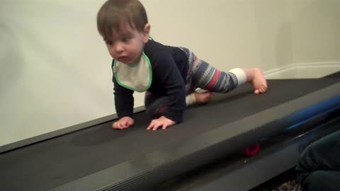 Determined baby hits the treadmill