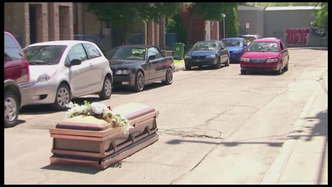 Coffin Blocks Cars from Driving By