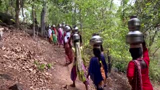 Indian villagers go into forest for pots of water