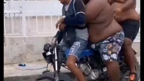 A fat man try to sit on bike