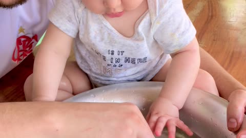 Baby Tries to Put Fish in Mouth During Sensory Activity
