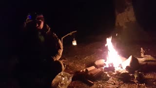 By a campfire . Riverside wildcamping.