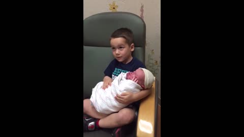 Older Brother's Hilarious Reaction To Holding Newborn Sibling For The First Time