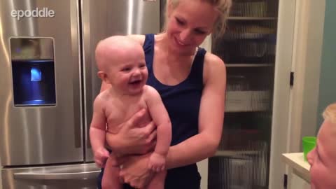 Baby adorably belly laughs at older brother
