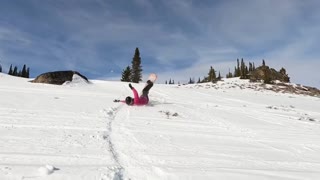 Female snowboarder wrecks on a step-down