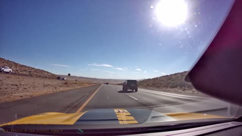 Tumbleweed Hits Car Hood Hard on Highway