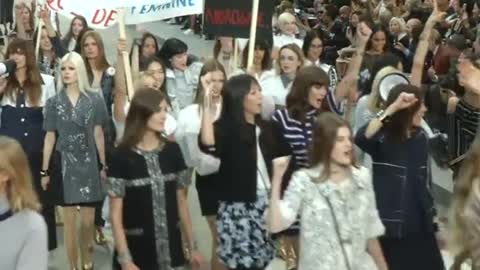 Chic "protesters" take Boulevard Chanel at Paris Fashion Week