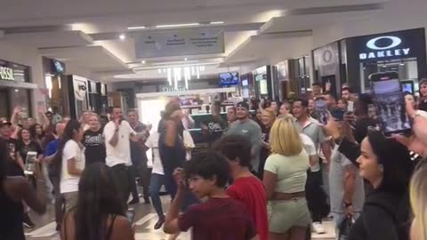 A CONGREGATION OF PEOPLE WALKED INTO FLORIDA MALL TO SPREAD THE WORD OF GOD