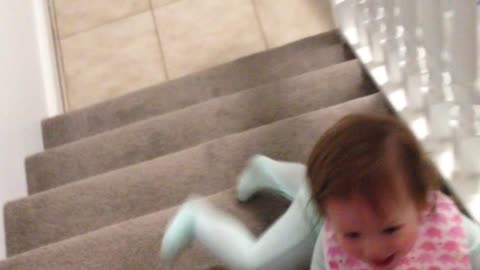 Baby slides down stairs on her stomach