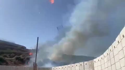 Israeli soldiers using old-school methods to clear vegetation by the Lebanese