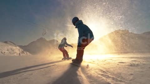 SPEED RAMP Two snowboarders riding towar