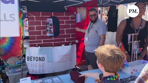 Adults encourage children to throw “bricks” at pictures of Republicans at PRIDE Seattle