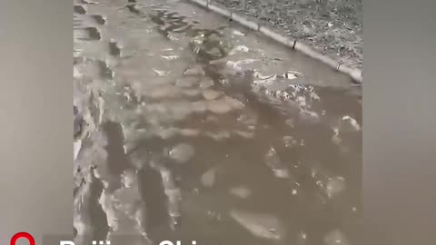 A video shows floodwaters left a very thick layer of mud in a community in Beijing