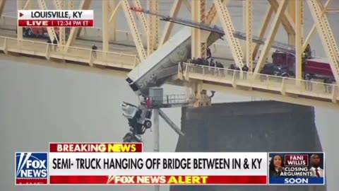 Semi-truck hanging off bridge between IN and KY