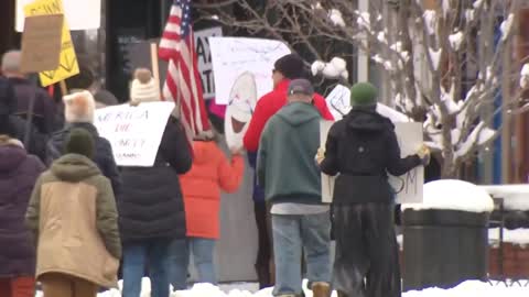 Demonstrators gathered on Saturday outside Colorado Gov. Jared Polis' home in Boulder to protest vaccine mandates