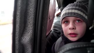 'We left our Dad in Kyiv' -little boy chokes back tears