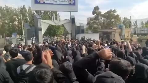 University security guards protect students in Sanandaj as Iranian security forces fire shots