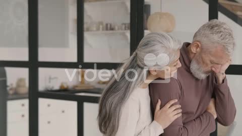 Middle Aged Man Having Headache At Home While His Wife Trying To Comfort Him