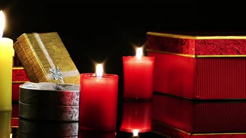 Candles and gifts on a dark background