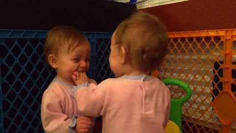 Twin babies share heart-warming moment