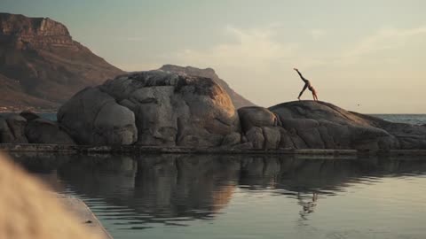 Woman Doing Yoga Over A Rock