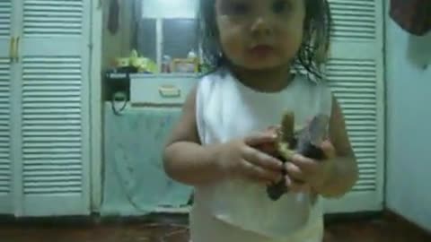 Playful 2 year old performs songs and dances for the camera