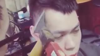 Man gets a hair cut with knife and hammer