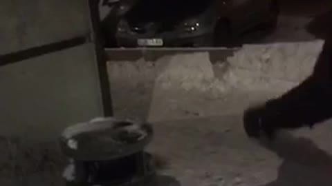 Guy black hoodie jumps on trash can slips and falls