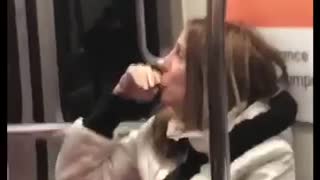 Woman sucks on her potato chip on subway train