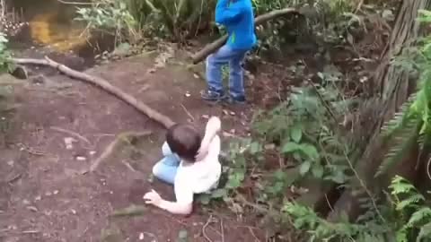 Tree stem fall over the kid while pour out into the river