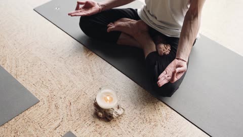 A Person Meditating On The Floor