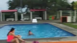 Guy gets volleyball thrown in face while walking to pool