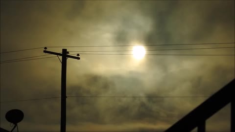 The Sun Through Power Lines and Clouds with a Nikon P900