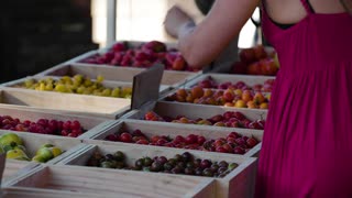 A woman choosing fruit at a market