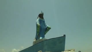 Filming the statue of Yemanja on top of a boat on the rocks, she looks out to sea [Nature & Animals]