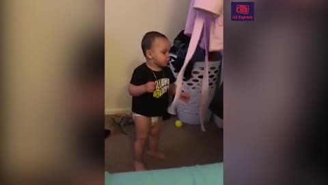 "Adorable baby boxer tries out moves"