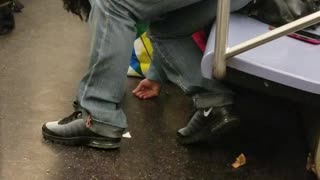 Grey pants woman passed out bent over seat subway