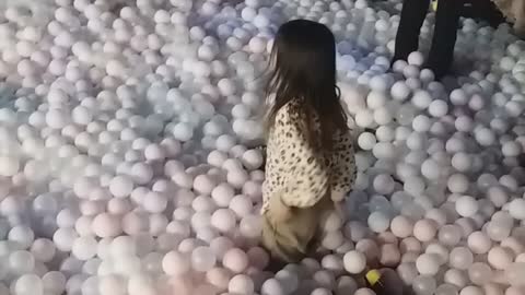 Children playing in the kids cafe ball pool