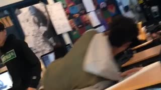 Guy jumps on table in class and breaks it