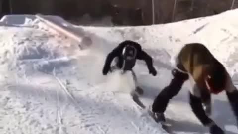 Snowboarder helmet accidentally nutshots snowboarder grinding rail