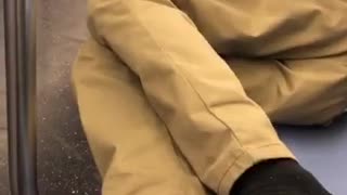 Guy puts his smelly feet out on subway seat