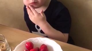 Artem eats strawberries