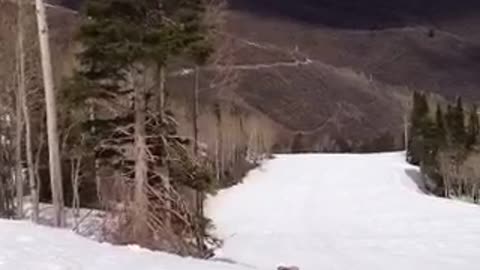 Snowboarder fails to clear a no jumping sign