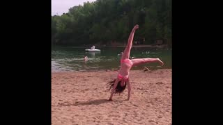 Girl fails cartwheel and face plants into sand