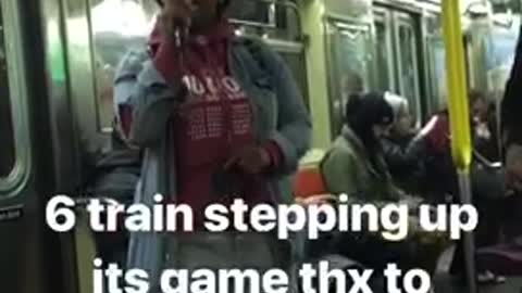 Woman in red hoodie sings beautifully on subway train, man plays red guitar