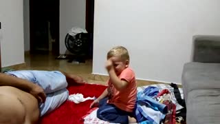 Little kid jumps off couch lands in pile of t-shirts