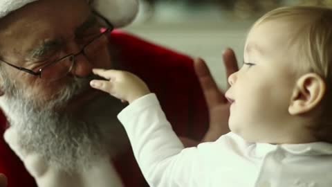 Santa making face at a baby