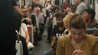 Guy in black shirt performs trick on train